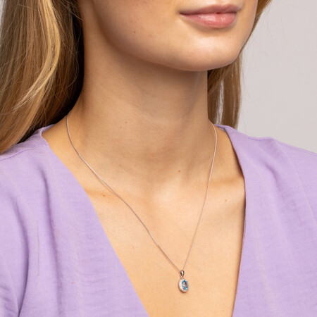 Halo Pendant with Blue Topaz and 0.04 carat TW of Diamonds in Sterling Silver Halo Pendant with Blue Topaz and 0.04 carat TW of Diamonds in Sterling Silver